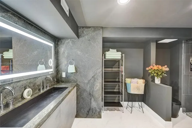 a living room with furniture and a floor to ceiling window