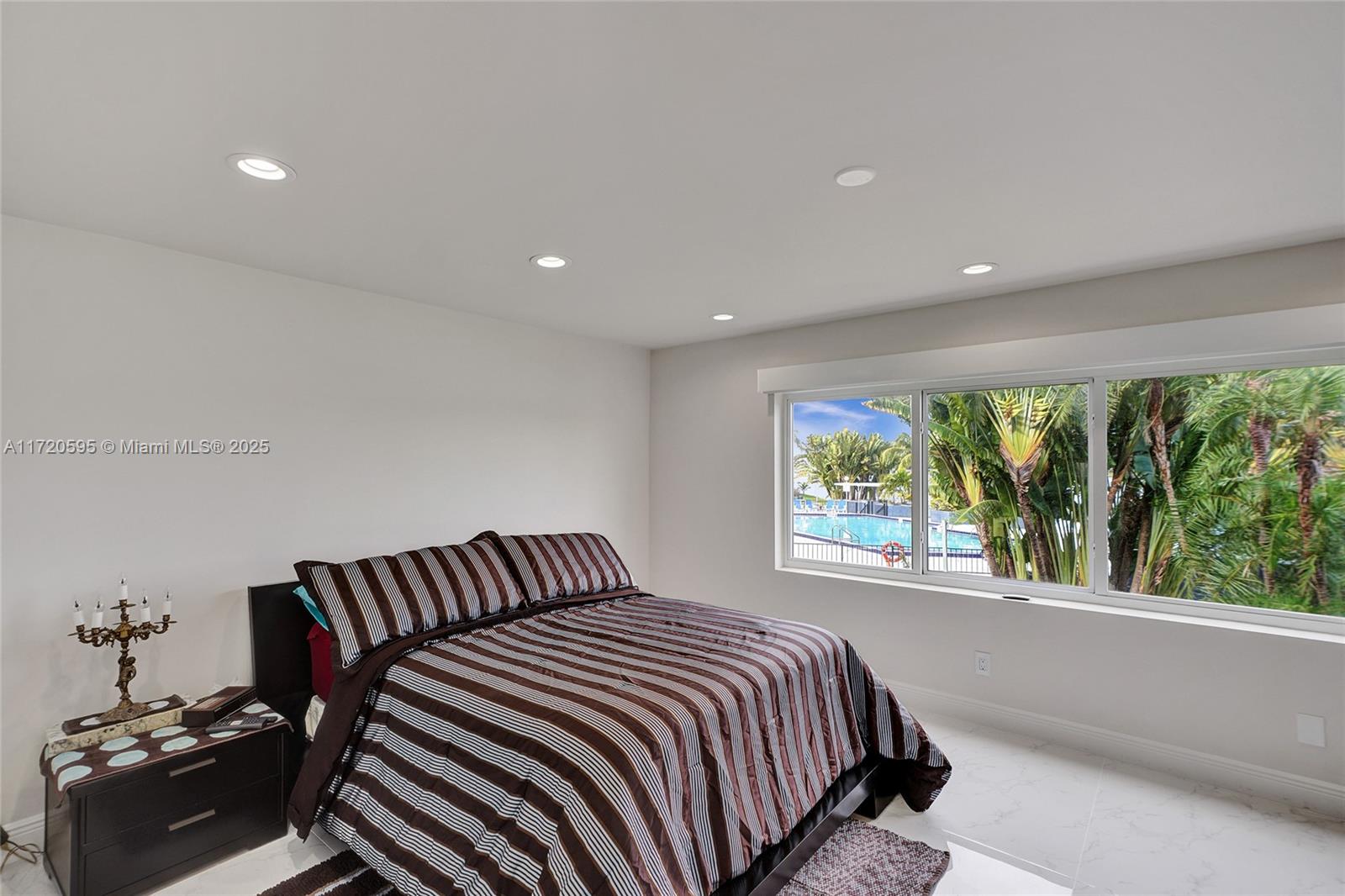 877 Northeast 195th Street, Unit 222 Miami, FL 33179 - Photo 50 of 93 a bedroom with a bed and a window
