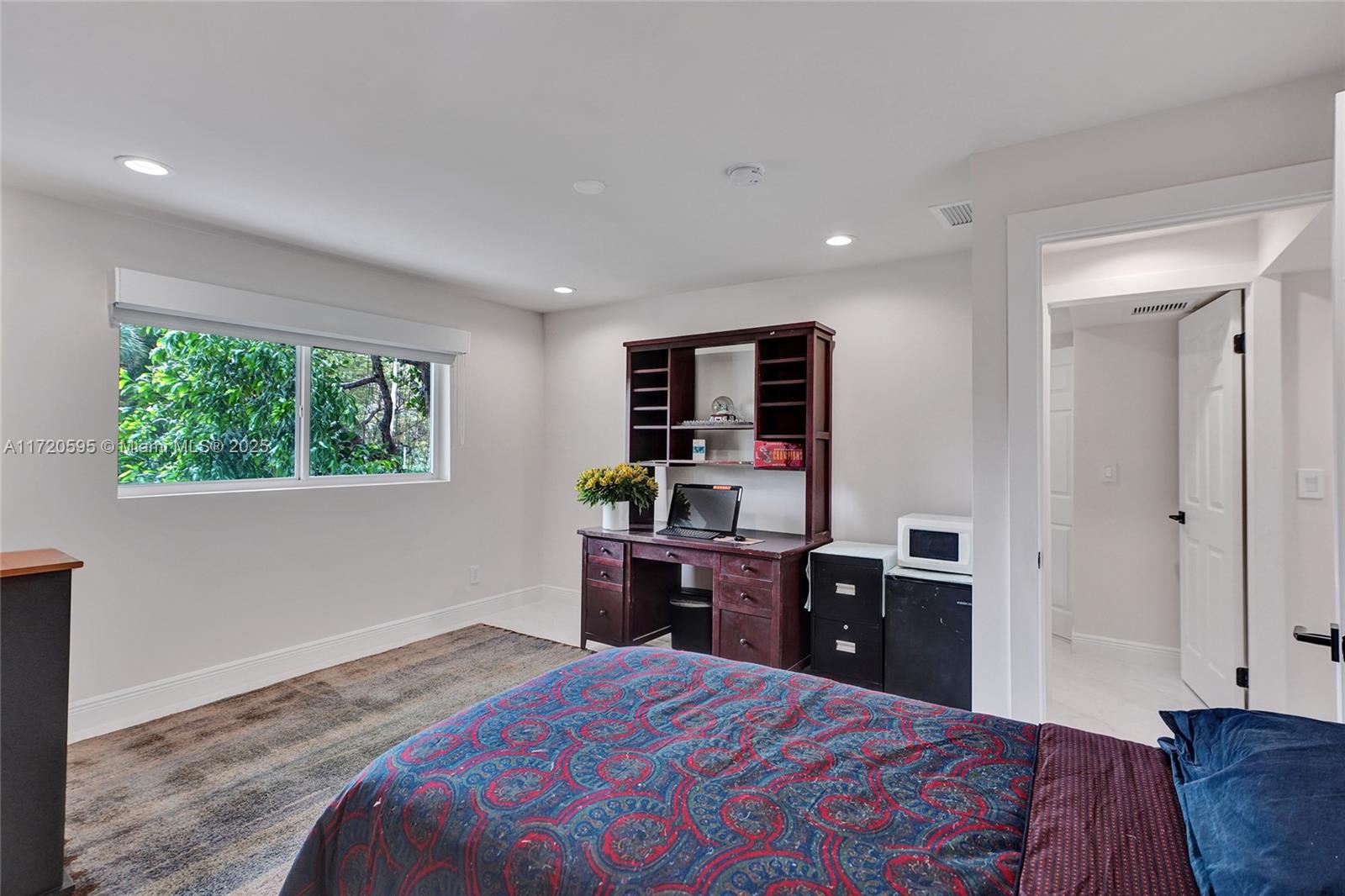 877 Northeast 195th Street, Unit 222 Miami, FL 33179 - Photo 56 of 93 a bed room with a bed and a television