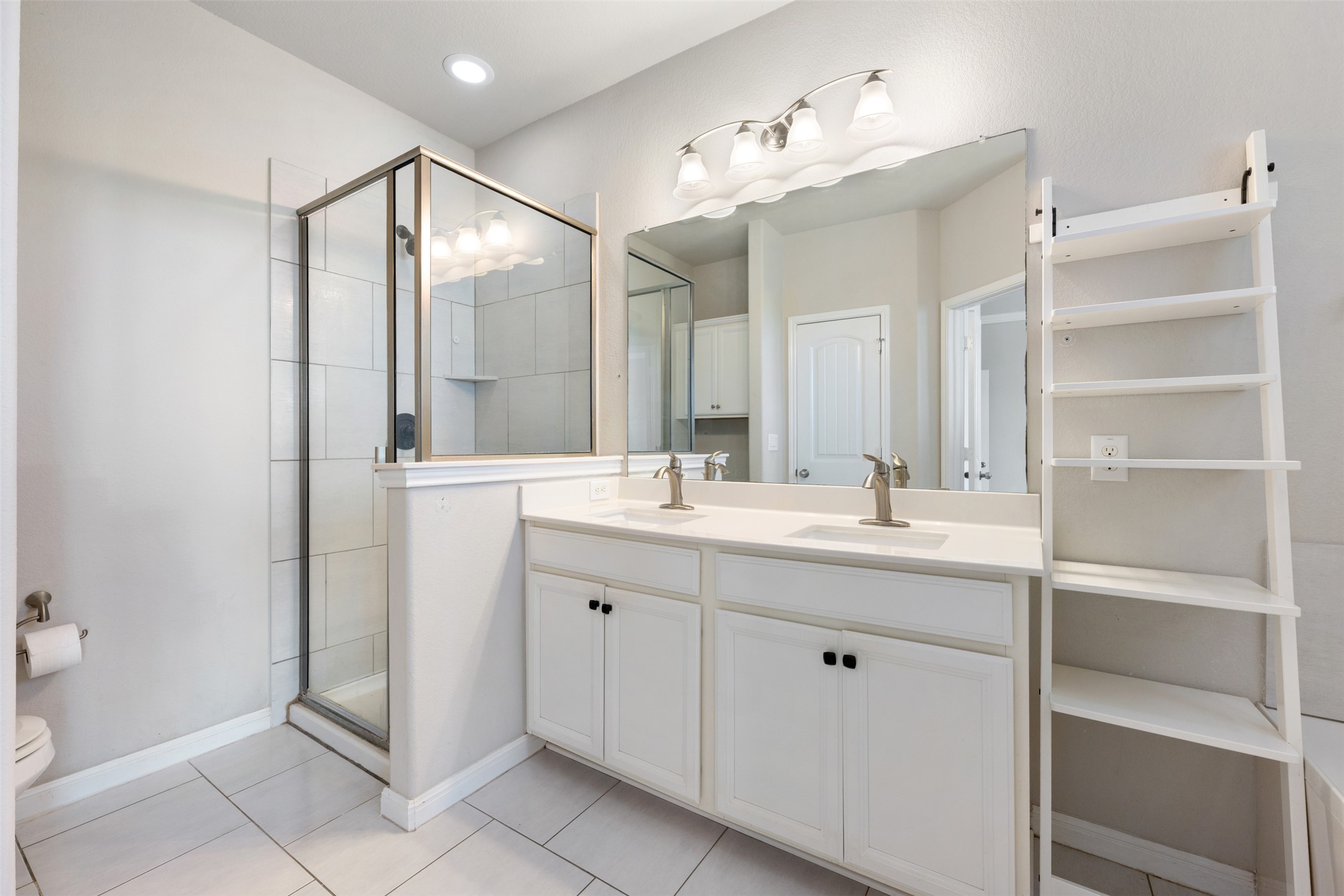 211 Parable Cove Pflugerville, TX 78660 - Photo 25 of 40 Double vanity with white cabinetry and brushed nickel hardware