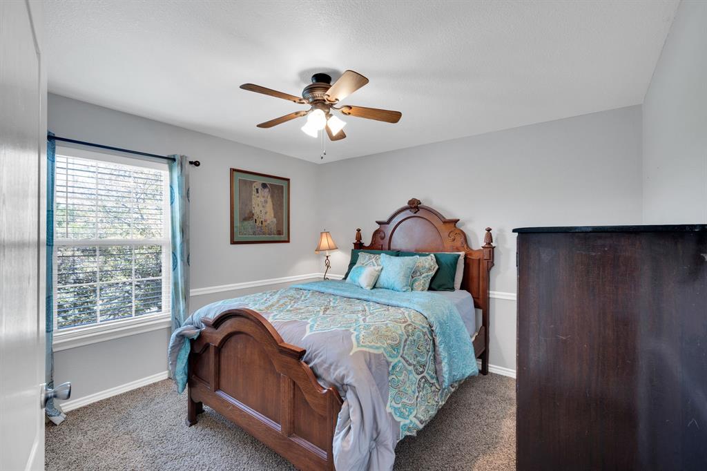 130 Eubanks Road Maypearl, TX 76064 - Photo 7 of 39 a bedroom with a bed and a chandelier