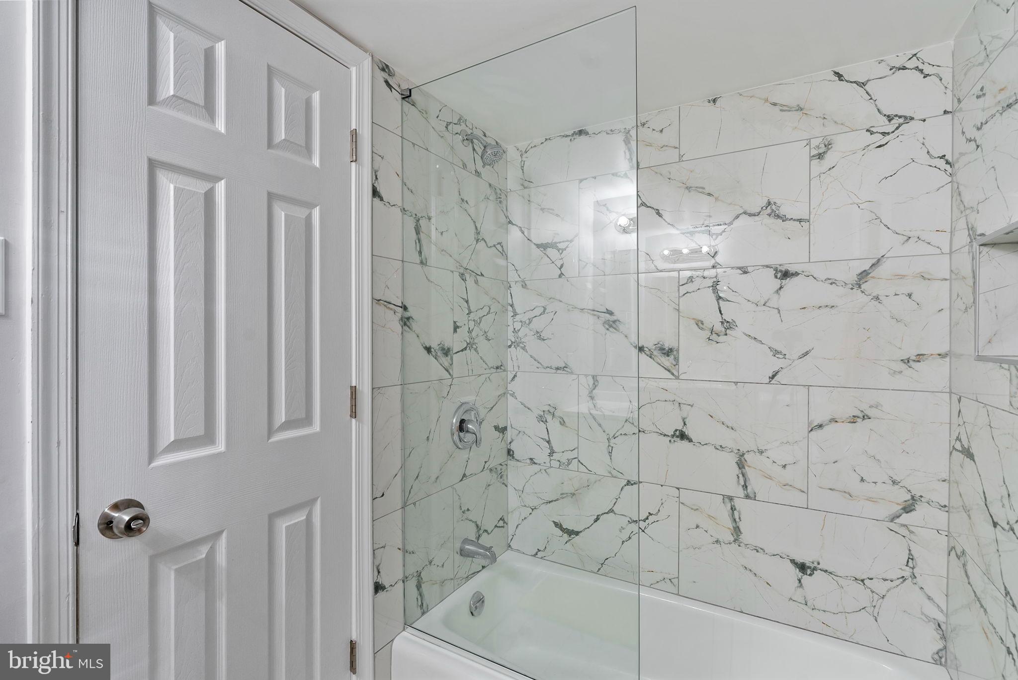 790 Quince Orchard Boulevard, Unit 202 Gaithersburg, MD 20878 - Photo 18 of 25 Elegant marble bath retreat with glass enclosure.