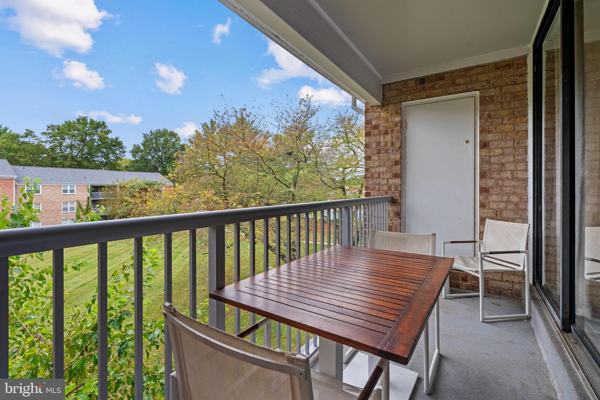 790 Quince Orchard Boulevard, Unit 202 Gaithersburg, MD 20878 - Photo 23 of 25 Serene balcony with lush green views.