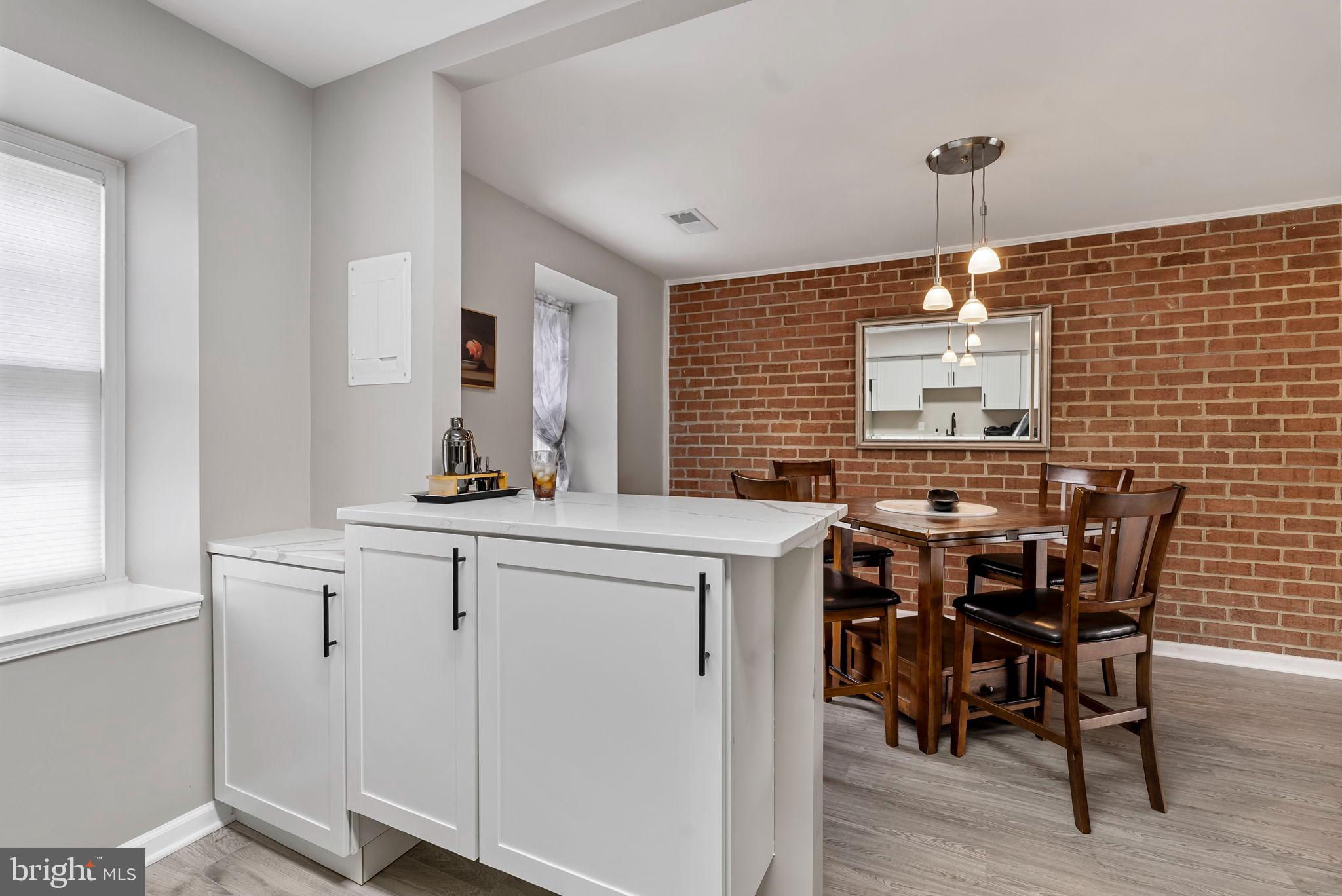 790 Quince Orchard Boulevard, Unit 202 Gaithersburg, MD 20878 - Photo 4 of 25 Custom dual function bar/cabinet open to dining