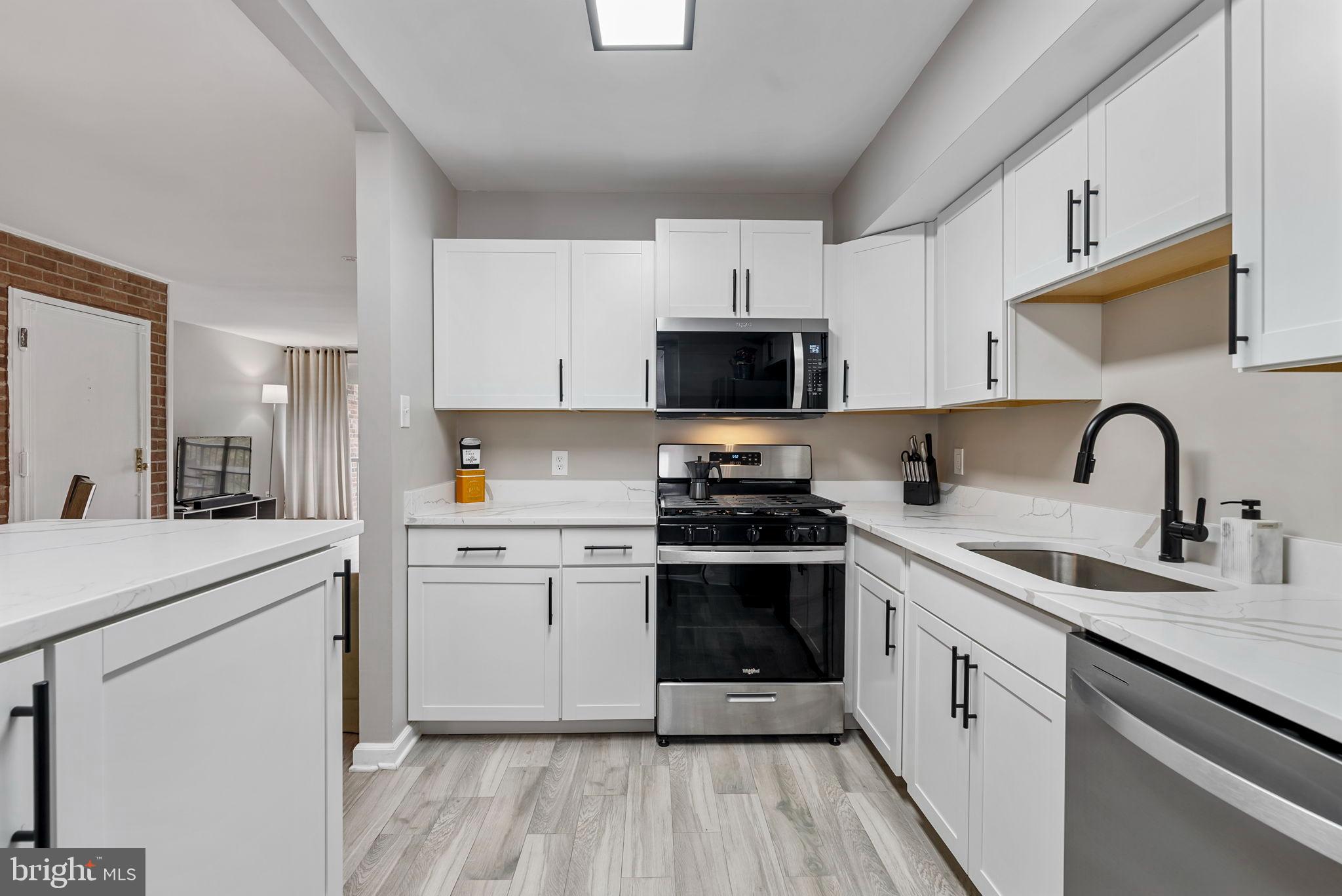 790 Quince Orchard Boulevard, Unit 202 Gaithersburg, MD 20878 - Photo 5 of 25 Sleek modern kitchen with stylish finishes.
