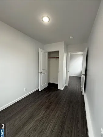 wooden floor in a hall with an empty room