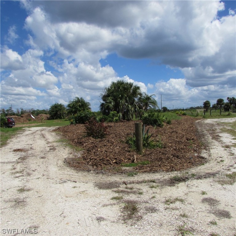 6700 Stringfellow Road St. James City, FL 33956 - Photo 2 of 25 a view of a dry yard with wooden fence