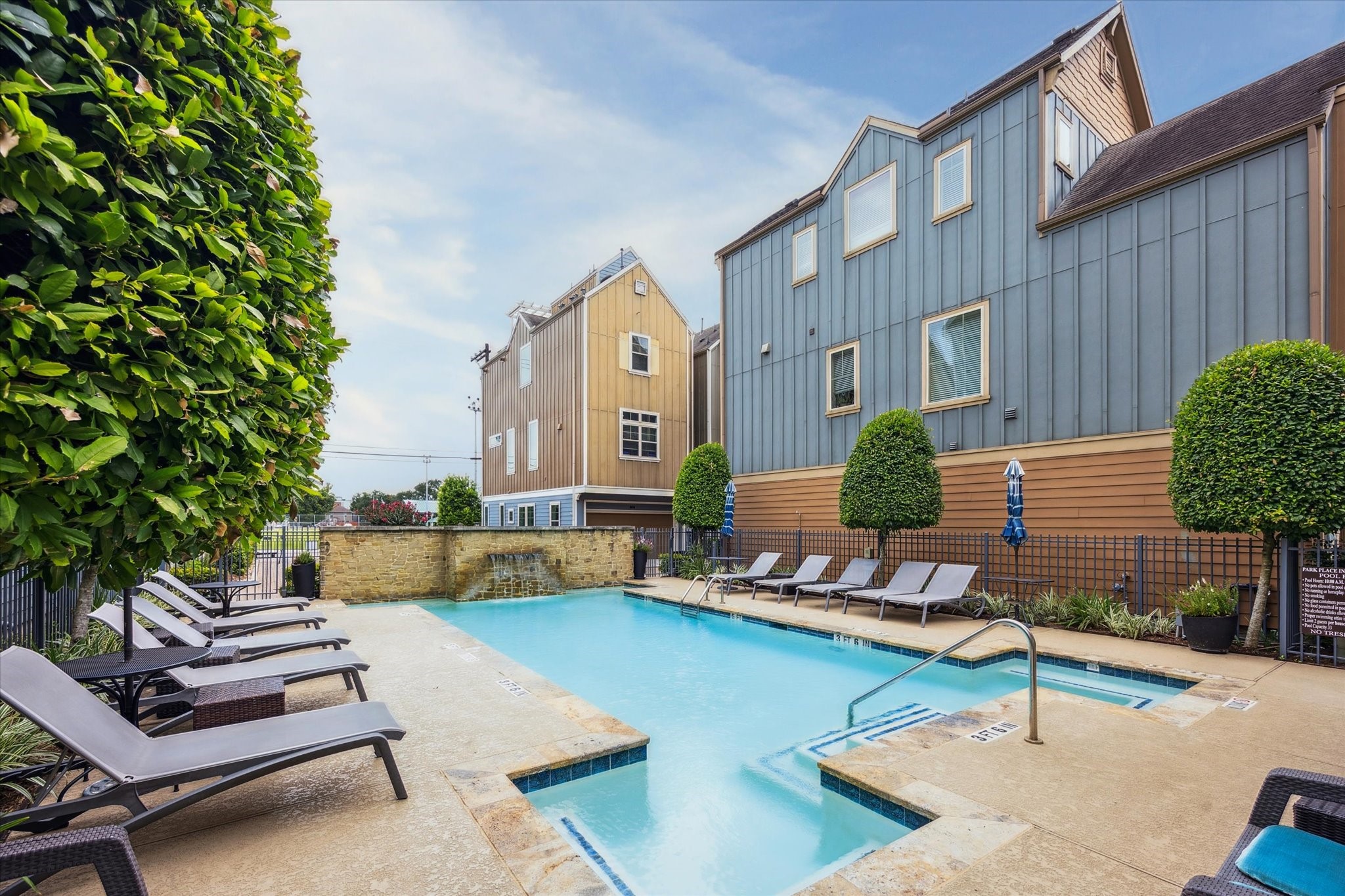 739 Dorothy Street Houston, TX 77007 - Photo 2 of 30 The community pool offers a refreshing escape just steps from home, complete with lounge chairs, manicured landscaping, and a tranquil waterfall feature. Whether relaxing poolside or taking a dip, it’s a convenient perk of this gated enclave.