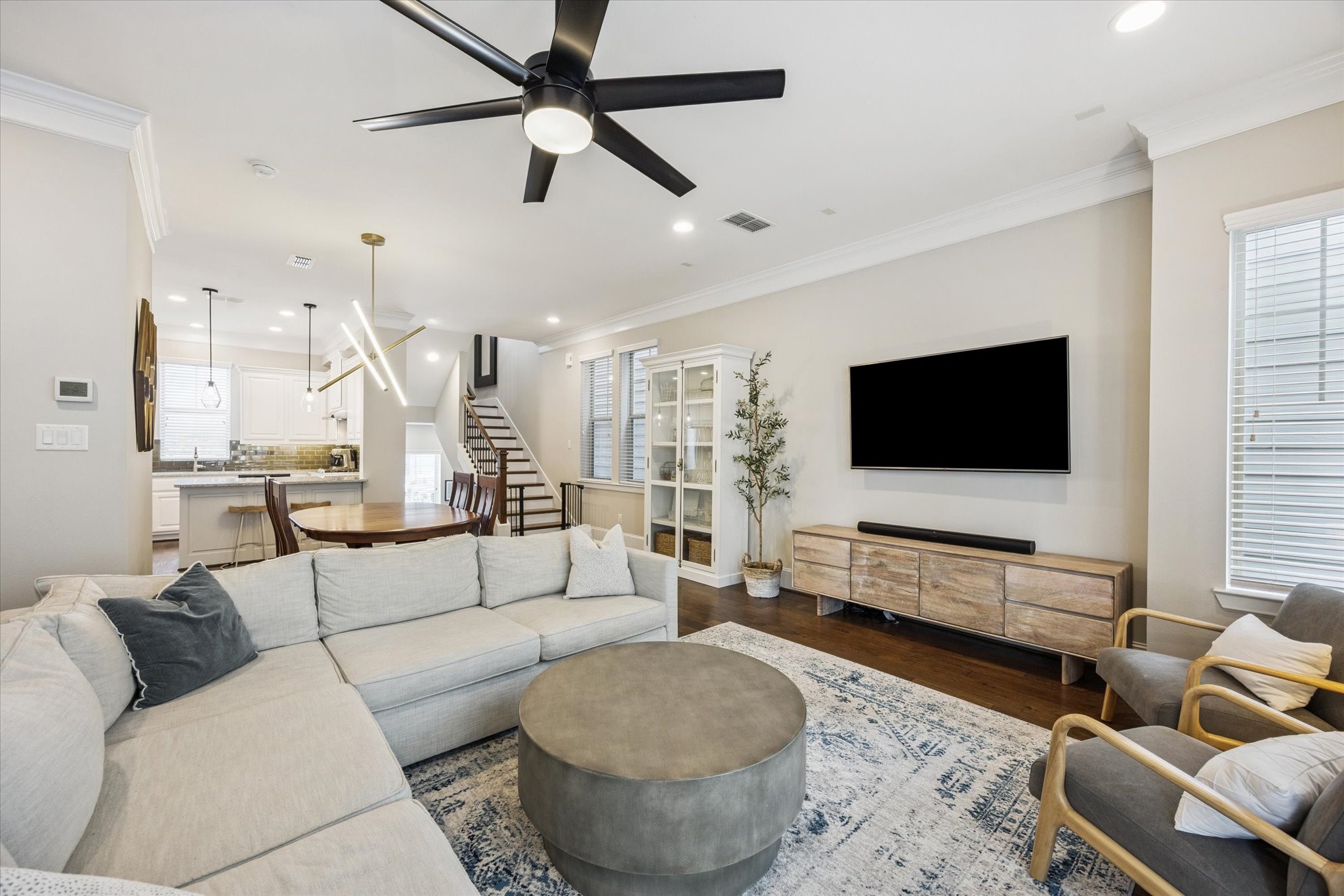 739 Dorothy Street Houston, TX 77007 - Photo 30 of 30 Open-concept design enhances connectivity between the kitchen, dining, and living areas, creating a cohesive atmosphere for gatherings. Thoughtfully placed stair access near the rear keeps the floor plan efficient while preserving openness and flow.