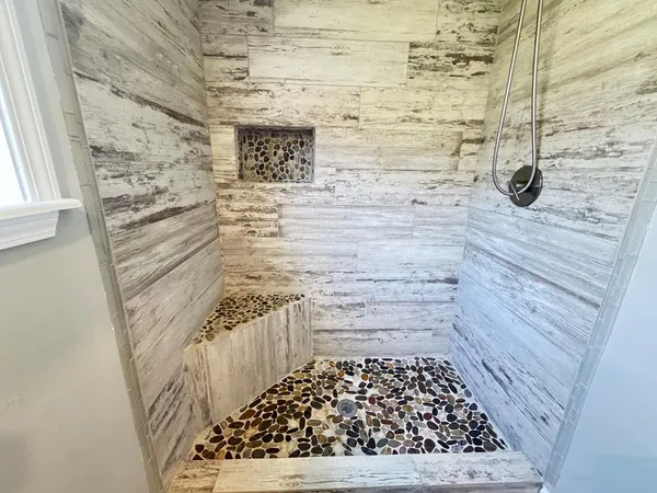 a bathroom with a wooden floor