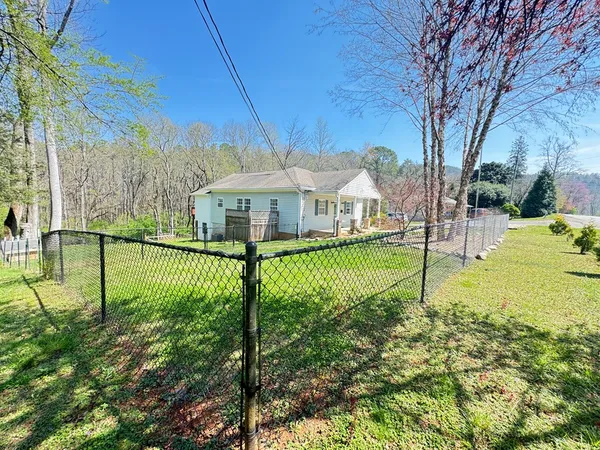 a swimming pool with barbeque oven in front of it