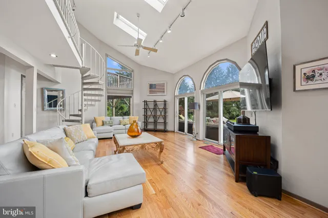 a living room with furniture fireplace and a large window