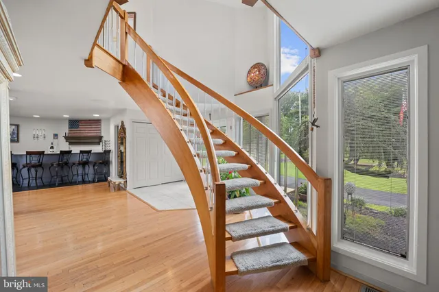 a view of staircase with wooden floor and a large window