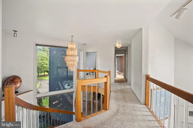 a view of a kitchen with an entryway and wooden floor