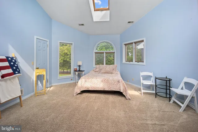 a spacious bedroom with a bed and a table