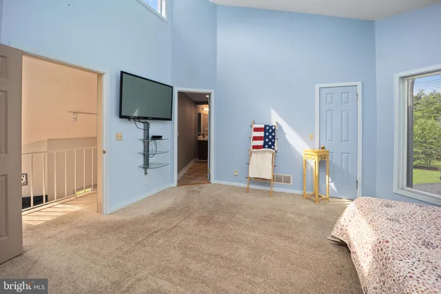 a view of a livingroom with wooden floor and a flat screen tv