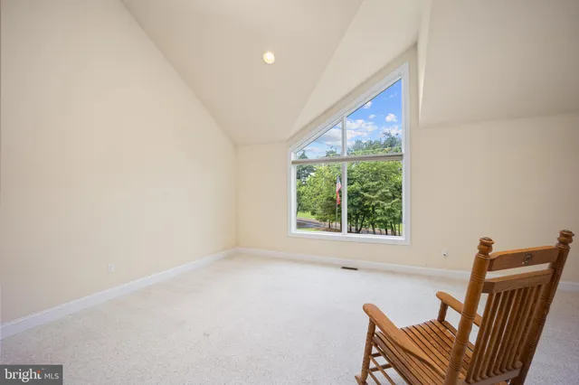 a view of a livingroom with a chair and a window