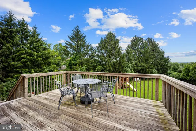 a view of a chair and table on the deck
