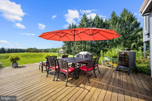 a view of a house with a big yard and potted plants
