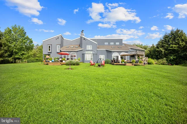 an aerial view of a house with a garden and swimming pool