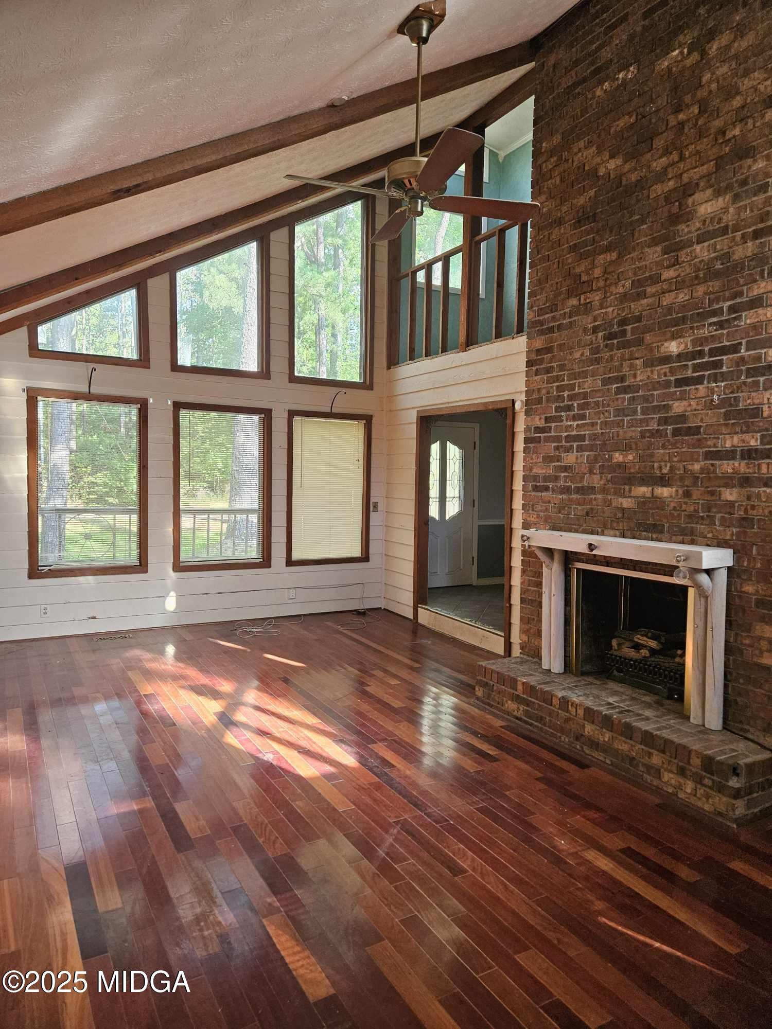 156 Rose Down Avenue Gray, GA 31032 - Photo 19 of 46 a view of an empty room with wooden floor fireplace and a window