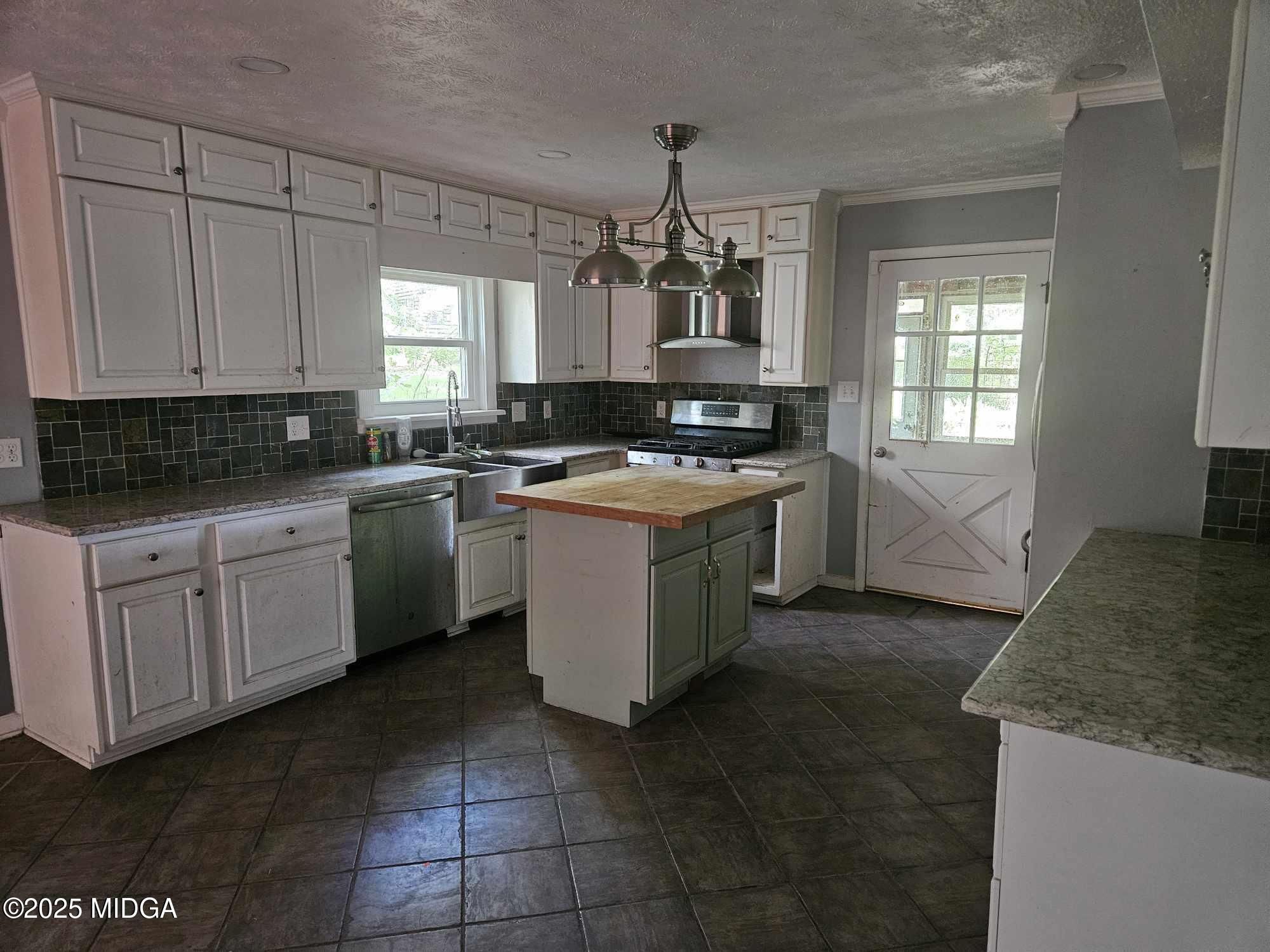 156 Rose Down Avenue Gray, GA 31032 - Photo 22 of 46 a kitchen with a stove sink and cabinets