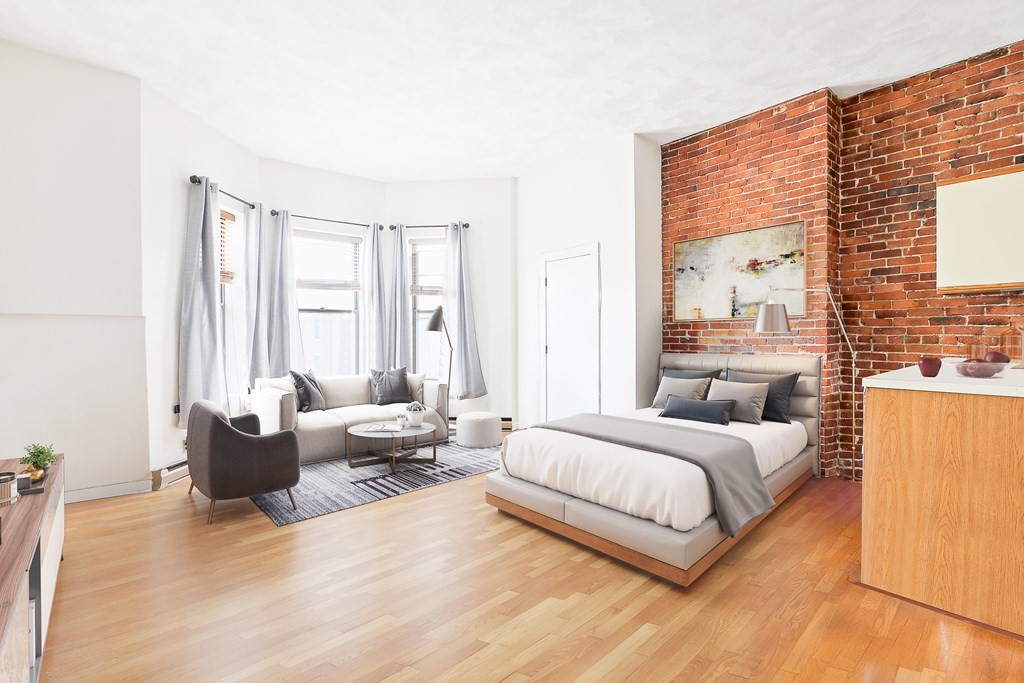 389 Beacon Street, Unit 7 Boston, MA 02116 - Photo 2 of 6 a bedroom with a bed and wooden floor