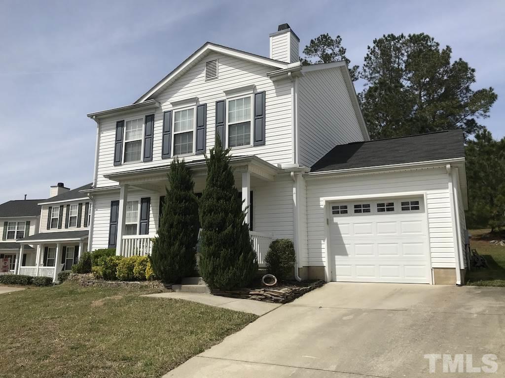 5213 Marthonna Way Raleigh, NC 27616 - Photo 1 of 15 a front view of a house with a yard and garage