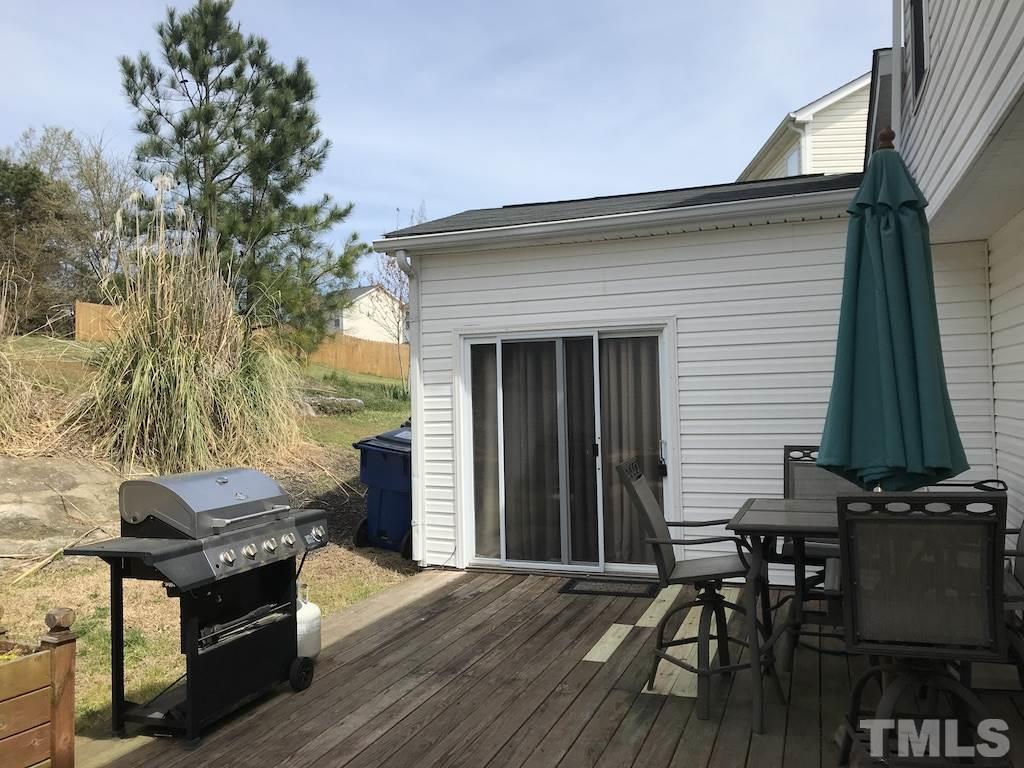 5213 Marthonna Way Raleigh, NC 27616 - Photo 14 of 15 a backyard of a house with wooden table and chairs