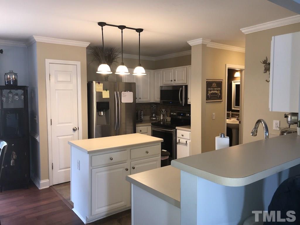 5213 Marthonna Way Raleigh, NC 27616 - Photo 3 of 15 a kitchen with a sink a stove and refrigerator