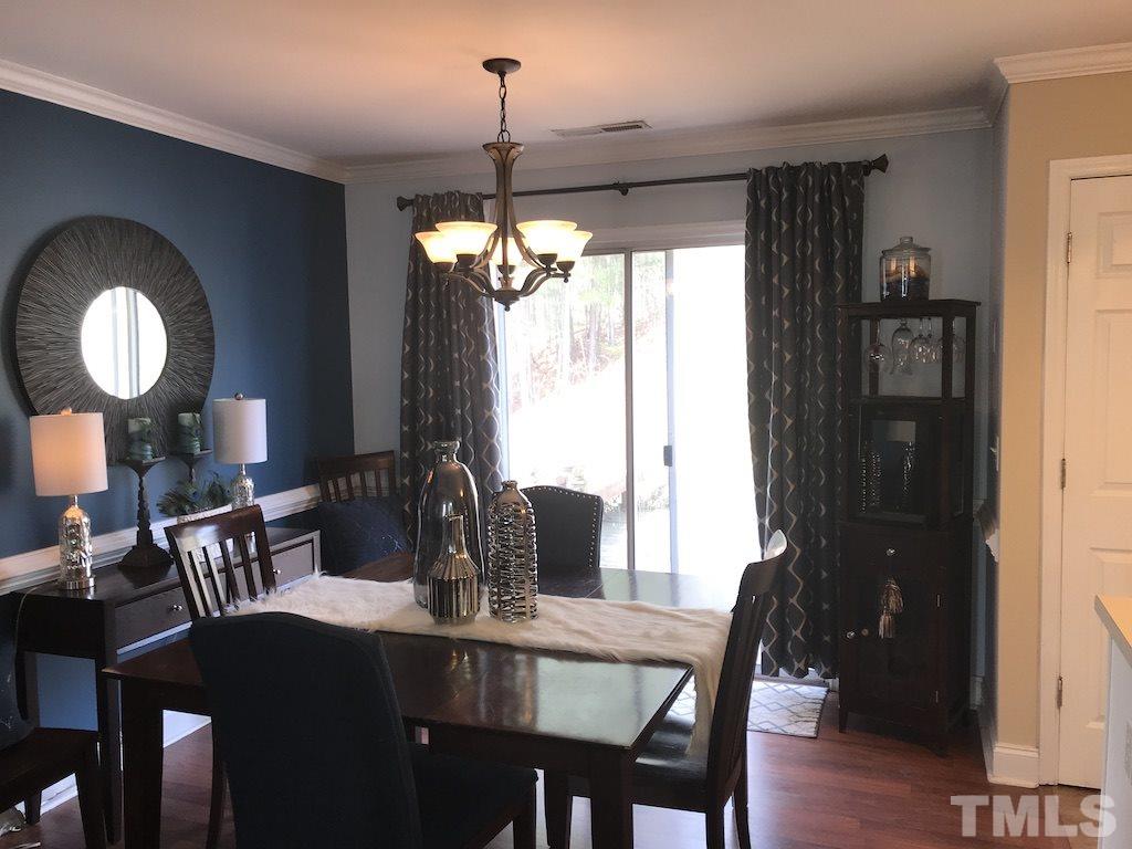 5213 Marthonna Way Raleigh, NC 27616 - Photo 4 of 15 a view of a dining room with furniture window and wooden floor