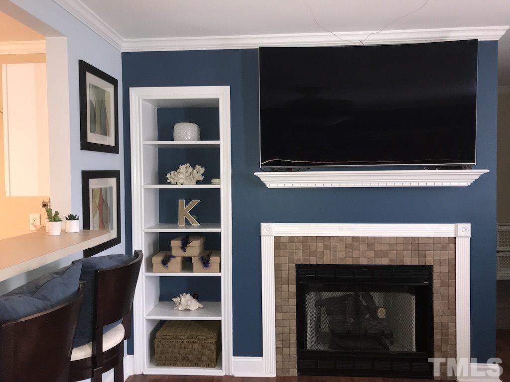 5213 Marthonna Way Raleigh, NC 27616 - Photo 6 of 15 a living room with a fireplace and a table