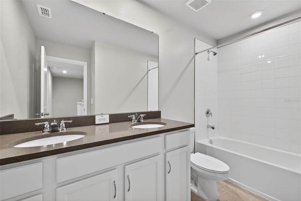 3352 Timber Xing Avenue Brandon, FL 33511 - Photo 27 of 35 a bathroom with a granite countertop sink toilet and shower