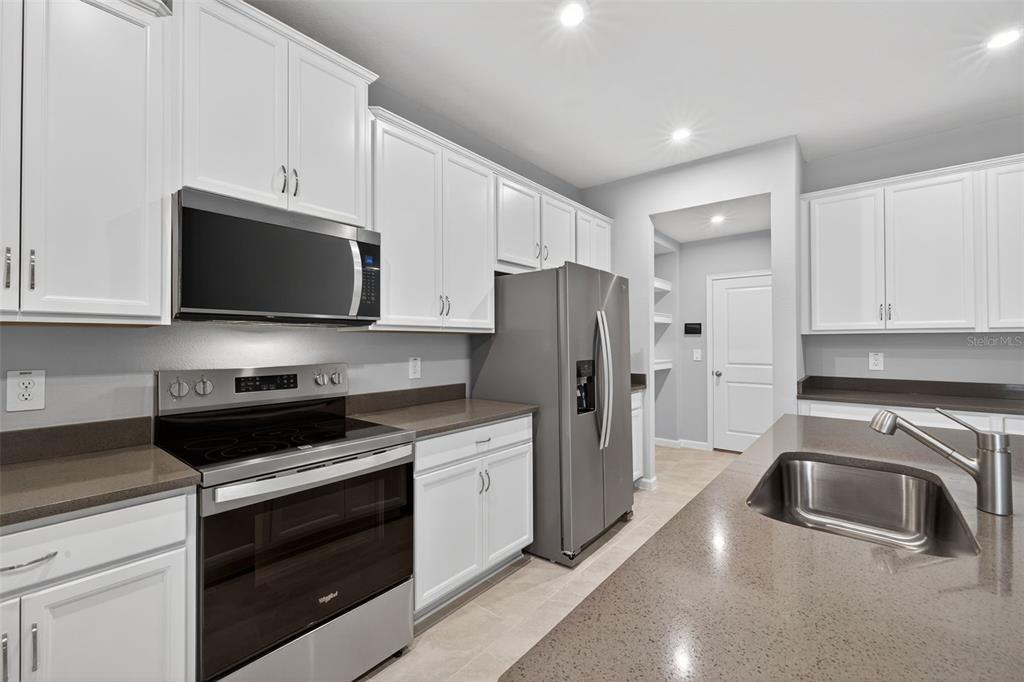3352 Timber Xing Avenue Brandon, FL 33511 - Photo 7 of 35 a kitchen with a sink stove and refrigerator
