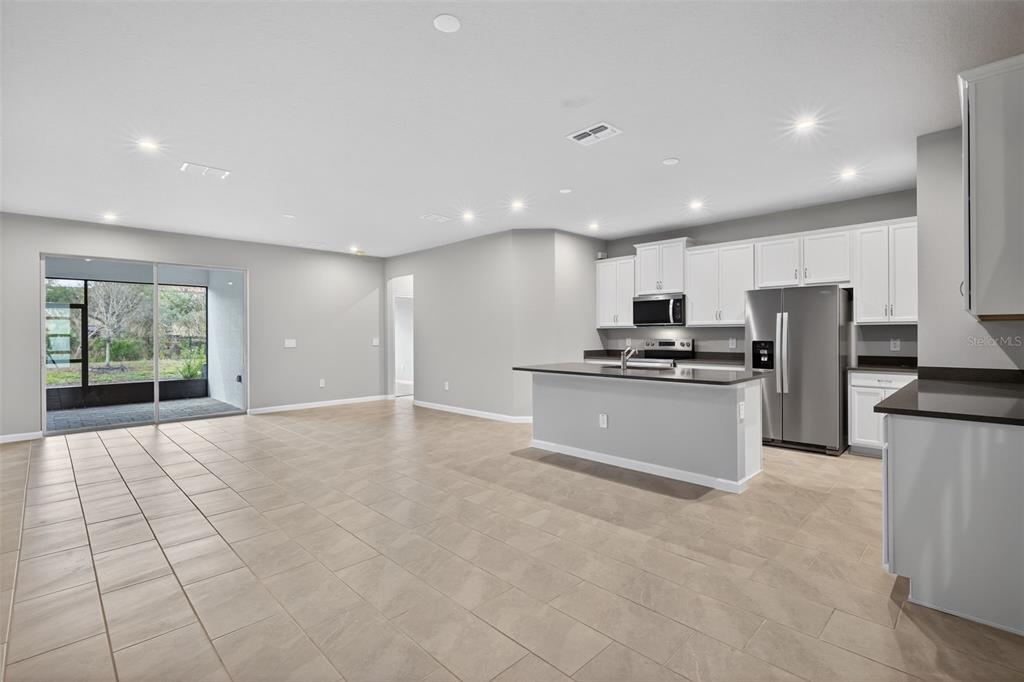 3352 Timber Xing Avenue Brandon, FL 33511 - Photo 10 of 35 a view of kitchen with kitchen island white cabinets and refrigerator