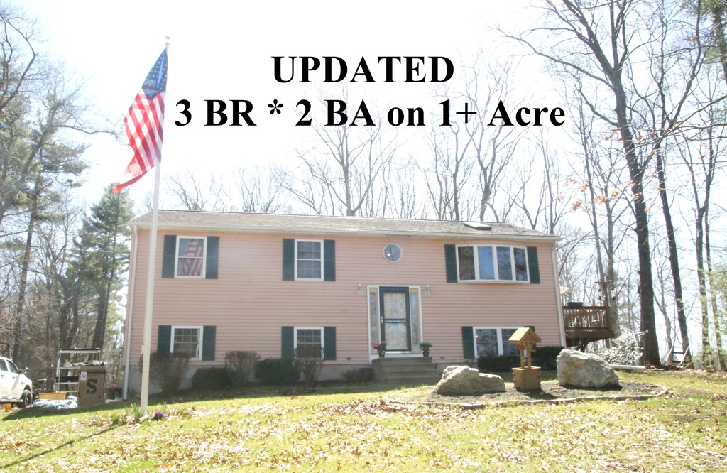 82 Baker Pond Road Dudley, MA 01571 - Photo 1 of 29 a front view of a house with a yard