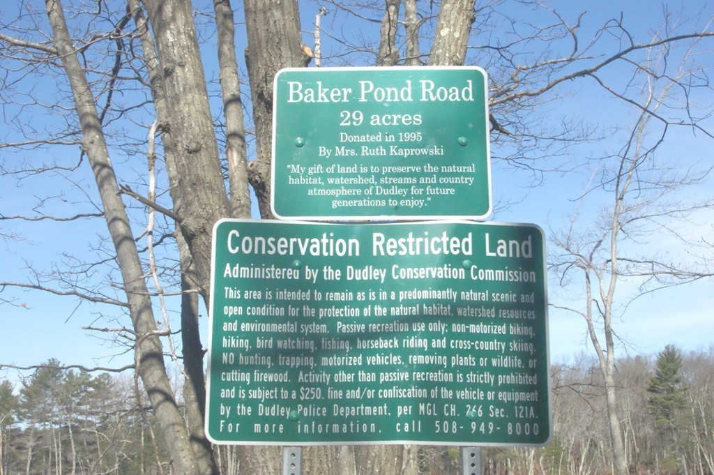 82 Baker Pond Road Dudley, MA 01571 - Photo 3 of 29 a sign on the brick wall