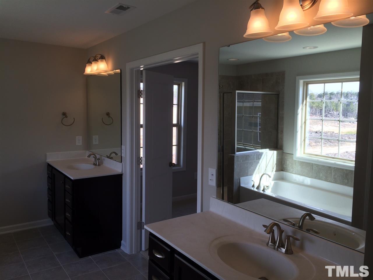 7533 Channery Way Raleigh, NC 27616 - Photo 14 of 25 separate vainities with cultured marble tops and attractive brushed nickel lighting