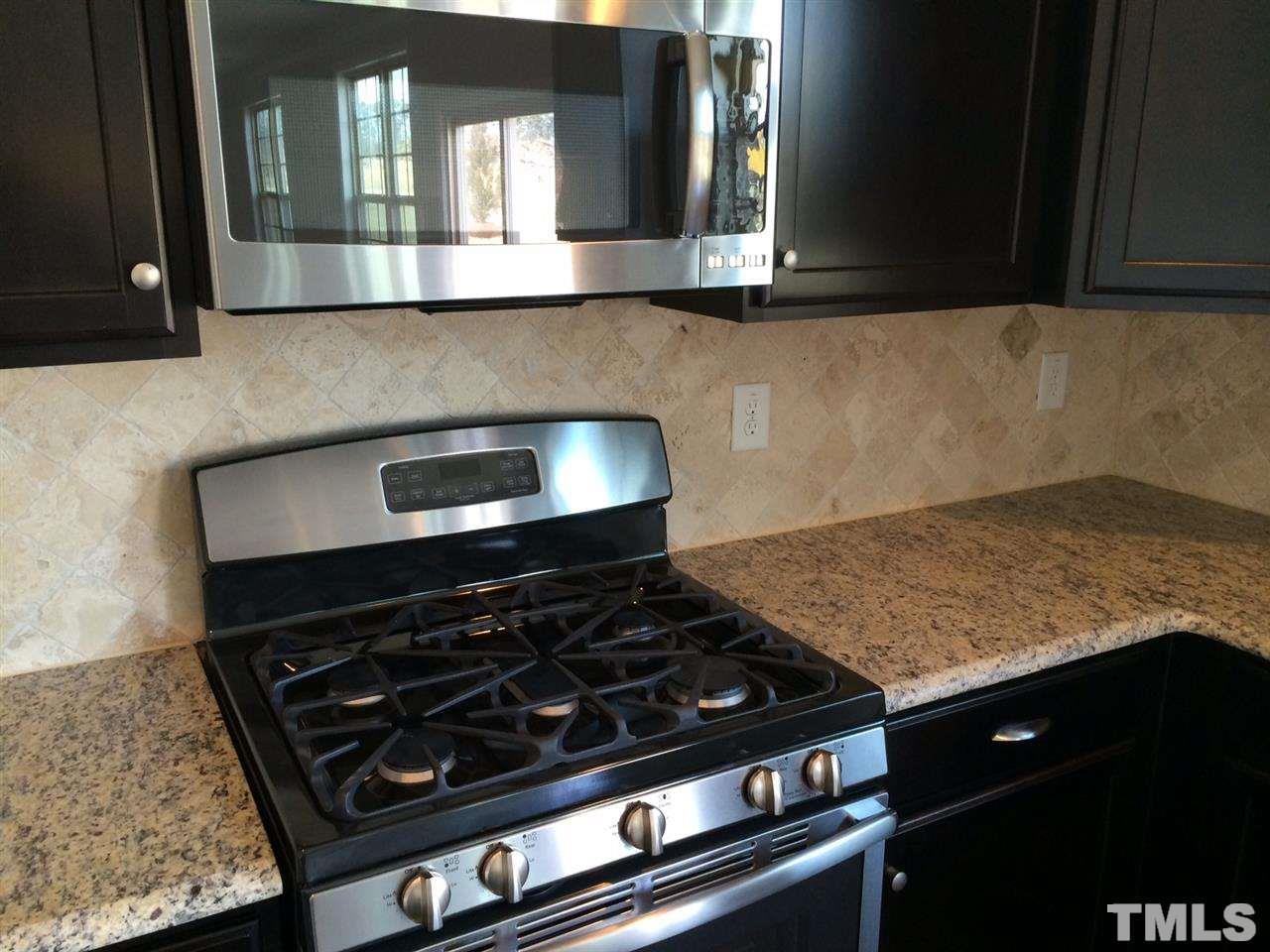 7533 Channery Way Raleigh, NC 27616 - Photo 7 of 25 gas range finishes off the stainless appliances