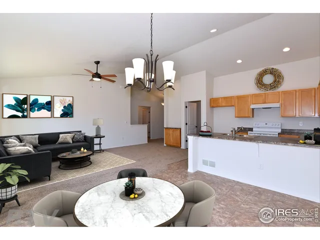 a kitchen with stainless steel appliances kitchen island granite countertop a sink a living room and living room view