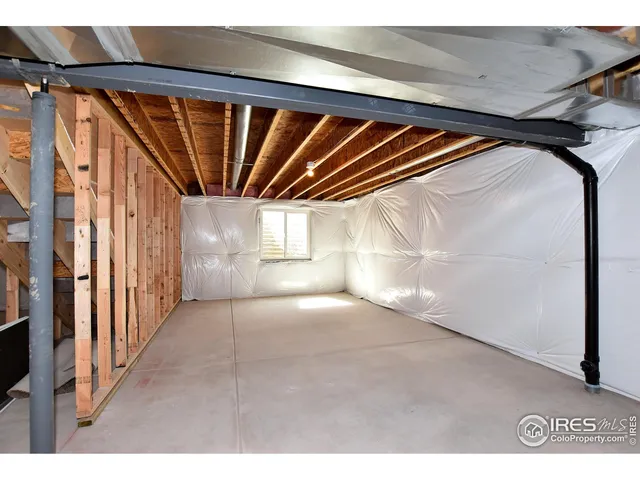 a view of an empty room with stairs and ventilation