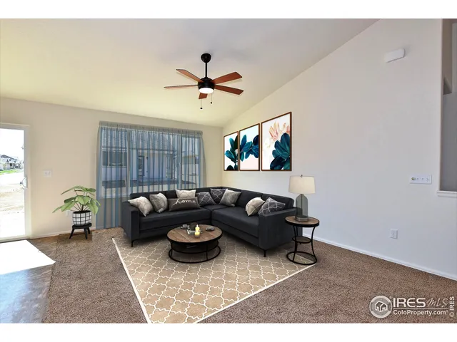 a living room with furniture and a hard wood floor