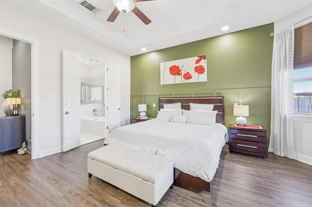 a spacious bedroom with a bed and a view of bathroom