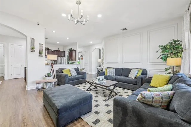 a living room with furniture and a chandelier