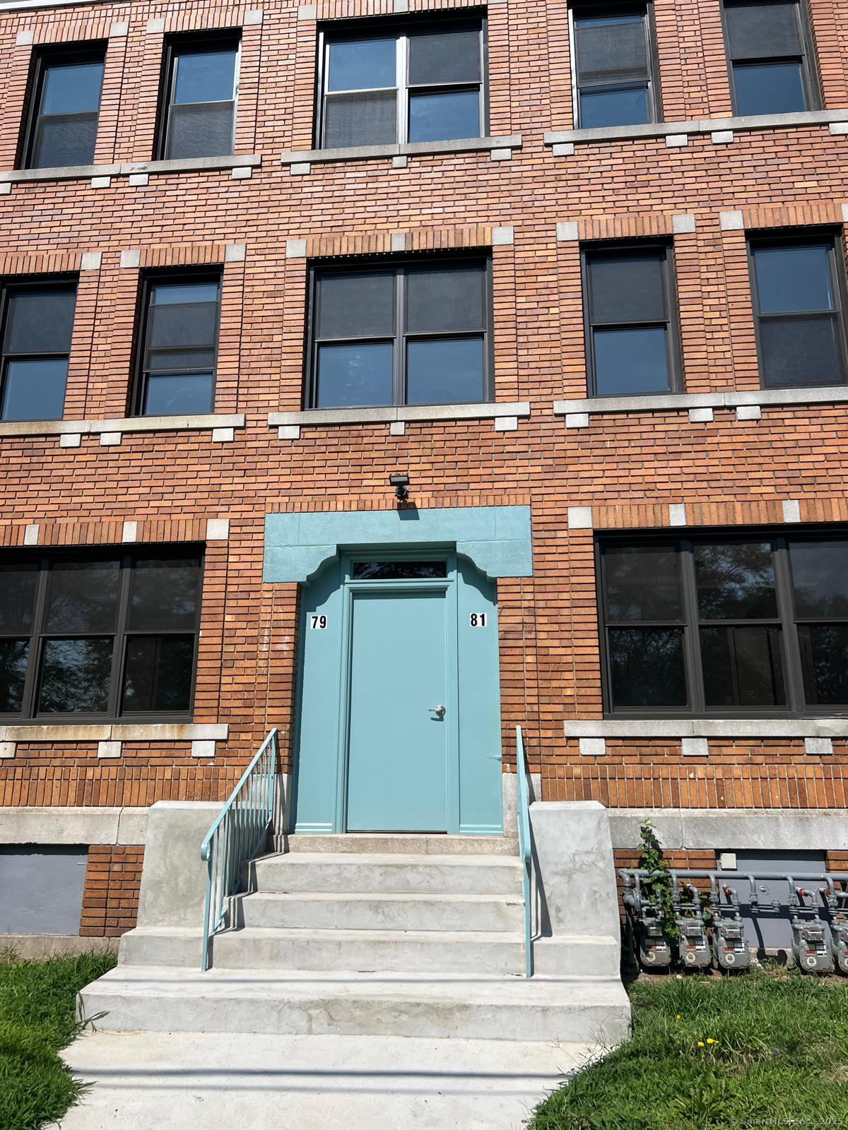 a view of front door of house with stairs