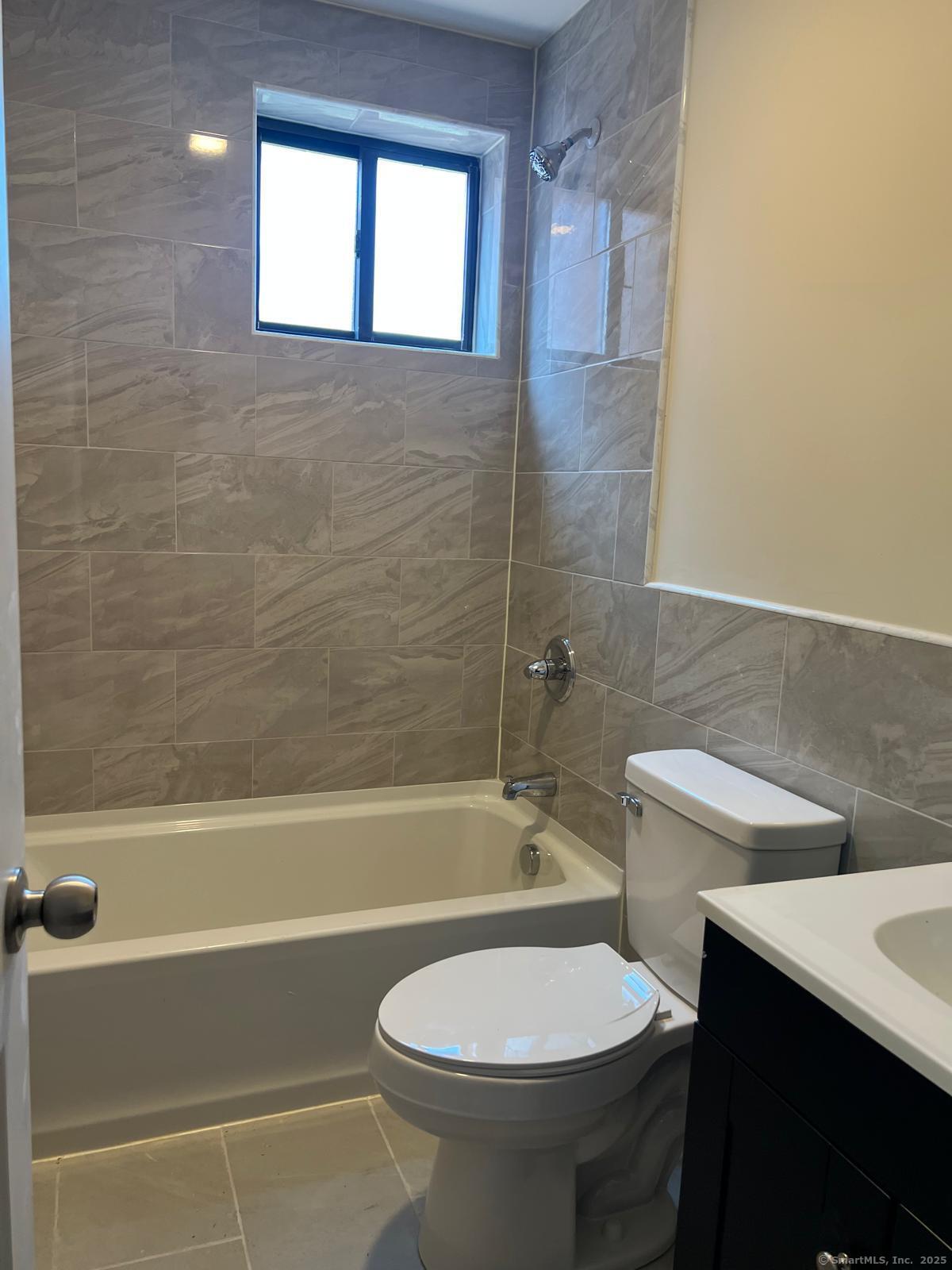 79 Barbour Street, Unit S2 Hartford, CT 06120 - Photo 6 of 7 a bathroom with a sink a toilet and bathtub