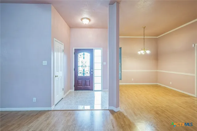 a view of a room with wooden floor and a bathroom