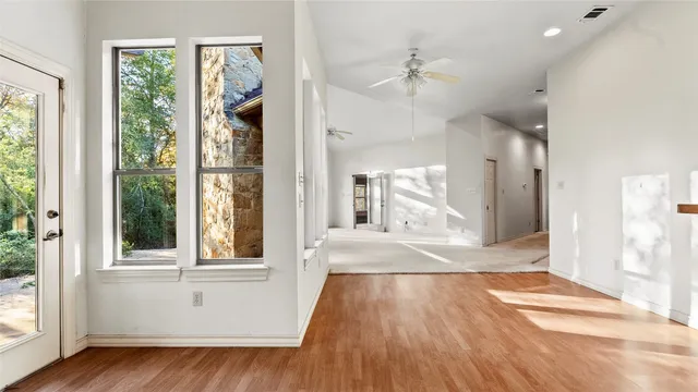 wooden floor in an empty room with a window