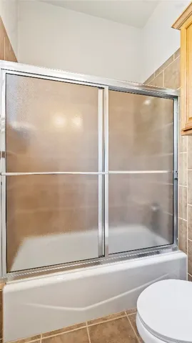 a bathroom with a shower and a bath tub
