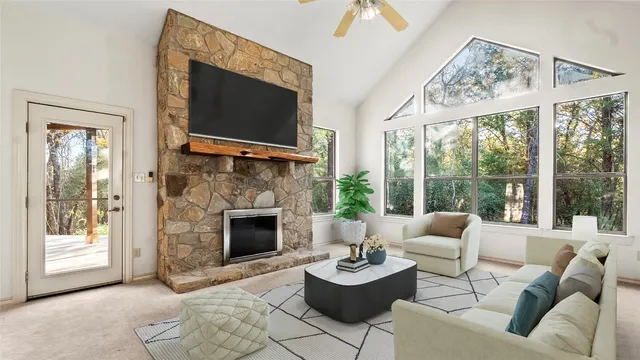 a living room with furniture a fireplace and a flat screen tv